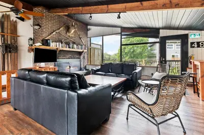 a living room with couches and a table and chairs at Semi Detached Mountain View Chalet in Blue Mountains