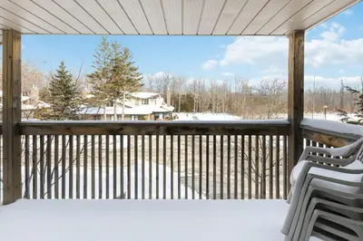 a screened porch with snow on the deck at Collingwood Chalet Near Blue Mountain Slopes 39A in Collingwood