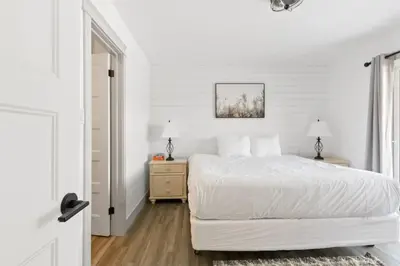 a white bedroom with a white bed and a window at Collingwood Chalet Near Blue Mountain Slopes 39A in Collingwood