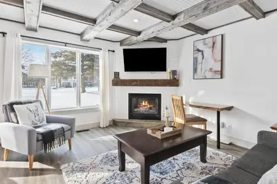 a living room with a fireplace and a tv at Collingwood Chalet Near Blue Mountain Slopes 39B in Collingwood