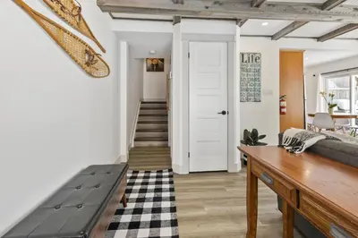 a living room with a bench and a door at Collingwood Chalet Near Blue Mountain Slopes 39B in Collingwood