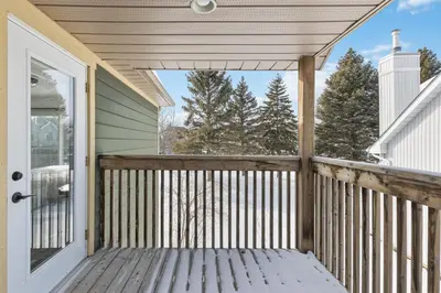 a front porch with a white door and trees at Collingwood Chalet Near Blue Mountain Slopes 39B in Collingwood