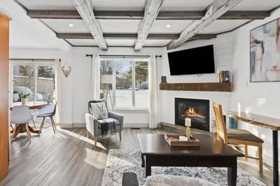 a living room with a fireplace and a tv at Collingwood Chalet Near Blue Mountain Slopes 39B in Collingwood