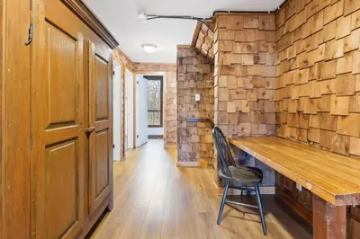 a wooden room with a wooden table and a chair at 3 Level Ski Chalet 7BR w Deck, Sauna & Ping-Pong! in Blue Mountains