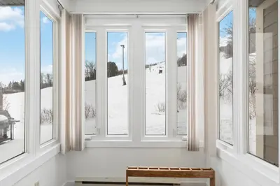 a room with windows with a view of snow at Blue Mountain Ski In Ski Out Resort Condo 2 Level in Blue Mountains