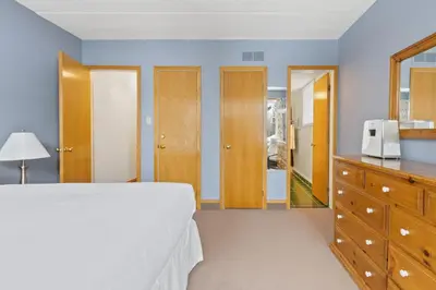 a bedroom with a bed and a dresser and a mirror at Blue Mountain Ski In Ski Out Resort Condo 2 Level in Blue Mountains