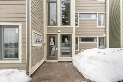 a house with snow in front of it at Blue Mountain Ski In Ski Out Resort Condo 2 Level in Blue Mountains