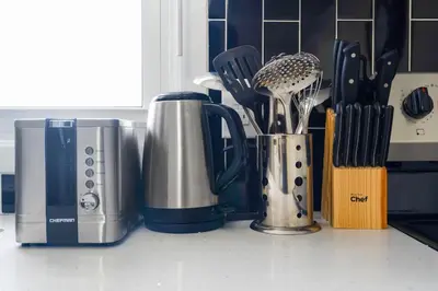a kitchen counter with utensils and appliances on a counter at Separate 3BR Family Friendly Apartments, Separate Floors, 5 Minutes Walk to The Fallsview with Free Parking & Wine in Niagara Falls