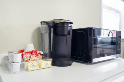 a kitchen counter with a microwave and a coffee maker at Separate 3BR Family Friendly Apartments, Separate Floors, 5 Minutes Walk to The Fallsview with Free Parking & Wine in Niagara Falls