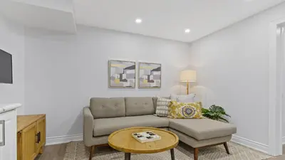 a living room with a couch and a table at Family Friendly - HOT TUB - Near Toronto & UOIT in Oshawa