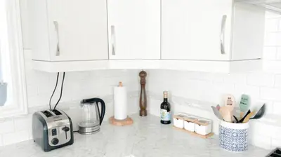 a kitchen counter with white cabinets and a toaster at Inspired Stay close to Niagara *4B & 2King Beds* in Thorold