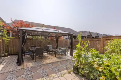 a patio with a table and chairs under a canopy at Inspired Stay close to Niagara *4B & 2King Beds* in Thorold