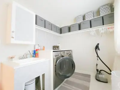 a laundry room with a washing machine and a sink at Inspired Stay close to Niagara *4B & 2King Beds* in Thorold