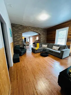 a living room with couches and a brick wall at Casa Maria Irena in Meaford