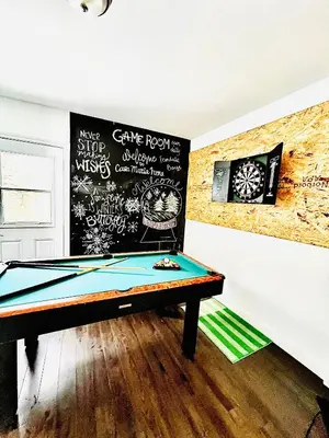 a pool table in a room with a wall with graffiti at Casa Maria Irena in Meaford
