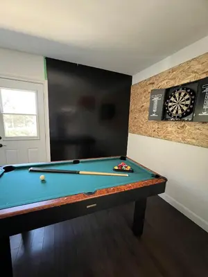a room with a pool table and a dart board at Casa Maria Irena in Meaford