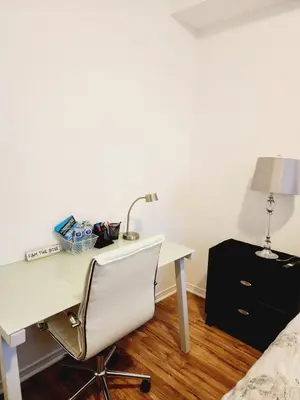 a white desk with a lamp and a bed at Beautiful Townhouse Near Yorkdale Mall, Wilson Subway in Toronto