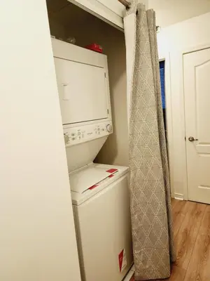 a white refrigerator freezer sitting in a kitchen at Beautiful Townhouse Near Yorkdale Mall, Wilson Subway in Toronto