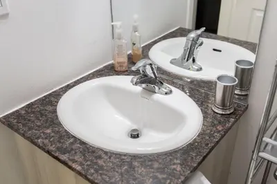 a bathroom counter with two sinks and a mirror at Beautiful Townhouse Near Yorkdale Mall, Wilson Subway in Toronto