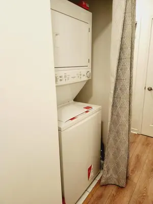 a white refrigerator freezer sitting inside of a kitchen at Beautiful Townhouse Near Yorkdale Mall, Wilson Subway in Toronto