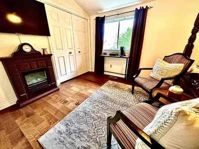 a living room with a couch and a fireplace at Settlers Suites in Niagara on the Lake