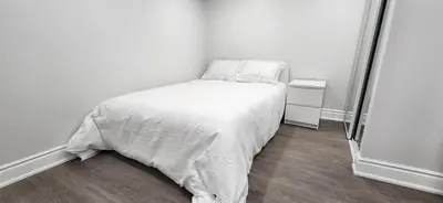 a small bedroom with a bed with white sheets and pillows at Cozy 2 Bedrooms & 2 Bathrooms Guest Suite with Electric Fireplace in Georgetown