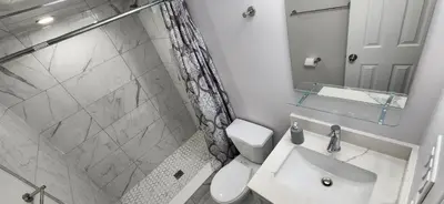 a bathroom with a toilet and a sink and a shower at Cozy 2 Bedrooms & 2 Bathrooms Guest Suite with Electric Fireplace in Georgetown