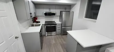 a kitchen with white cabinets and stainless steel appliances at Cozy 2 Bedrooms & 2 Bathrooms Guest Suite with Electric Fireplace in Georgetown