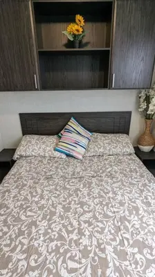 a bed with a pillow on it in a bedroom at Subu's Paradise in Niagara in Niagara on the Lake