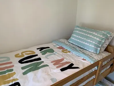 a bed with a comforter and a pillow on it at All Season Cottage close to Long Beach in Wainfleet
