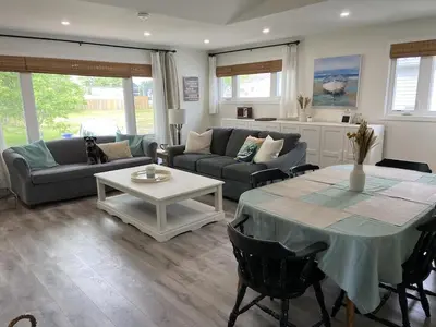 a living room with a couch and a table at All Season Cottage close to Long Beach in Wainfleet