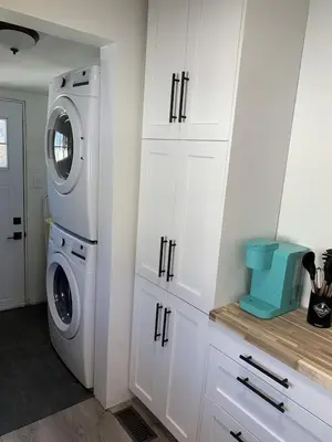 a kitchen with a washing machine and a washer at All Season Cottage close to Long Beach in Wainfleet