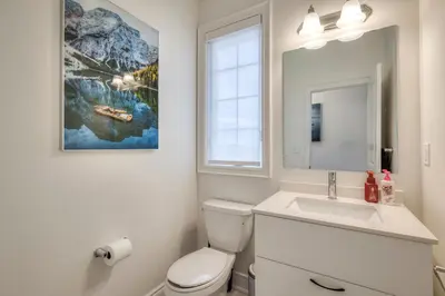 a bathroom with a white toilet and a sink at Masterfully Designed Private Suite in Bradford