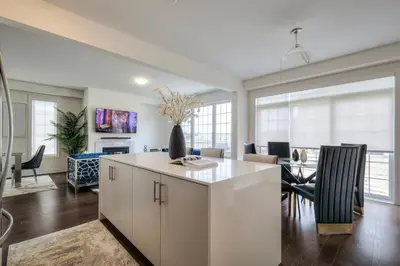 a kitchen and living room with a table and chairs at Masterfully Designed Private Suite in Bradford