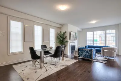 a living room with a couch and a table and chairs at Masterfully Designed Private Suite in Bradford