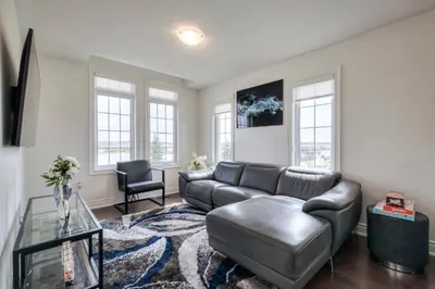 a living room with a couch and a table at Masterfully Designed Private Suite in Bradford