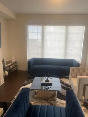 a living room with a blue couch and a table at Your Perfect Getaway Master Bedroom in Bradford