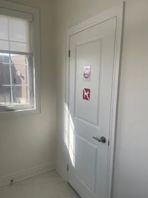 a white door with a no smoking sign next to a window at Your Perfect Getaway Master Bedroom in Bradford