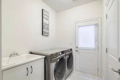 a laundry room with a washing machine and a sink at Your Perfect Getaway Master Bedroom in Bradford