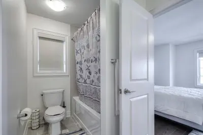 a white bathroom with a toilet and a bed at Relax, Refresh and Recharge Peaceful Space in Bradford