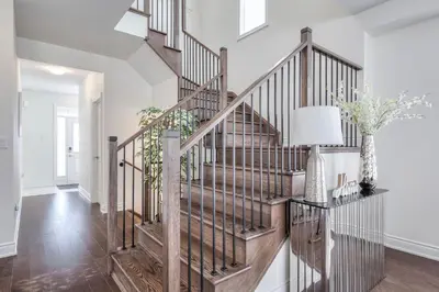 a staircase in a home with white walls and wood floors at Relax, Refresh and Recharge Peaceful Space in Bradford