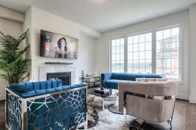 a living room with blue furniture and a fireplace at Unwind Here in a Stylish and Cozy Space in Bradford