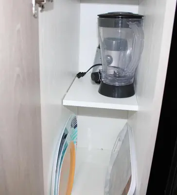 a blender sitting on a shelf in a kitchen at Modern Town House Barrie South in Barrie