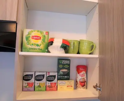 a kitchen pantry with food items on shelves at Modern Town House Barrie South in Barrie