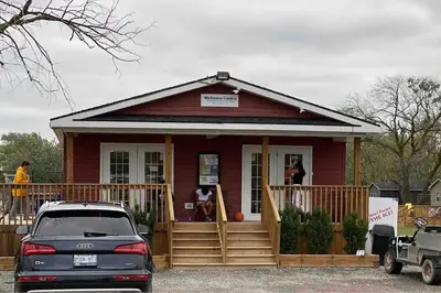 a red house with a car parked in front of it at Falcon Cottages in Niagara on the Lake